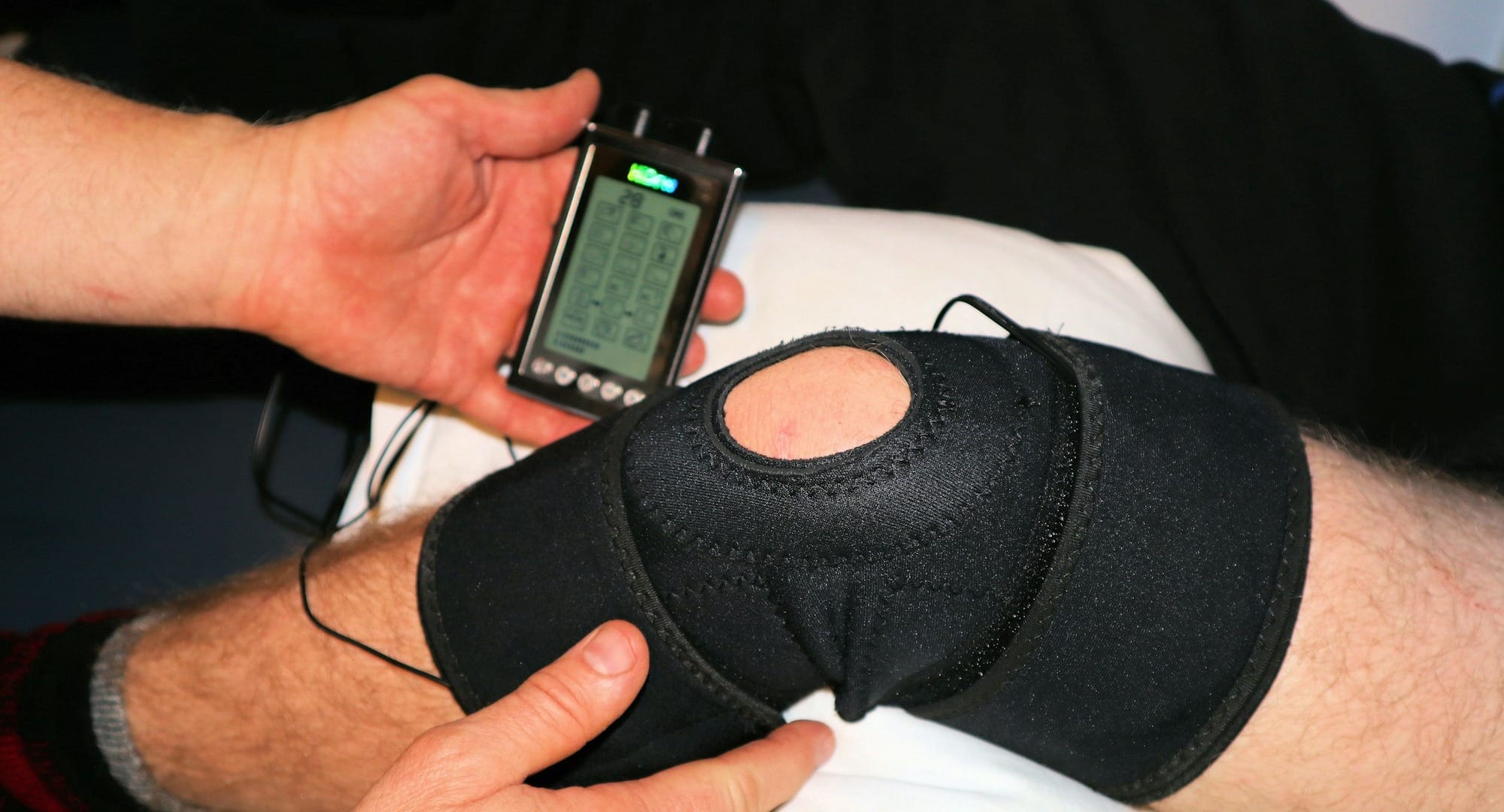 person holding black knit cap